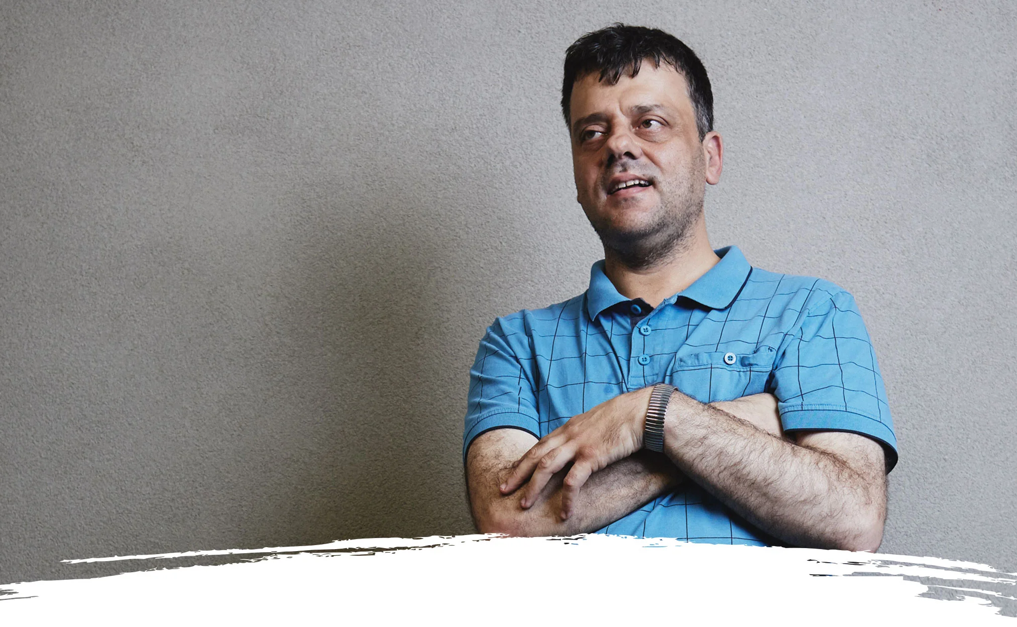 photo of a man standing in front of a grey wall imagining better